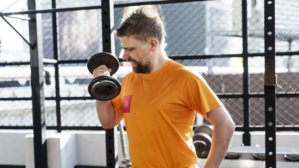 Beginner lifting weights to build muscle in a gym.